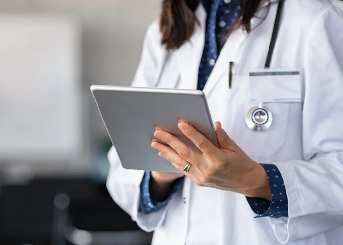 doctor holding tab Helping members of community